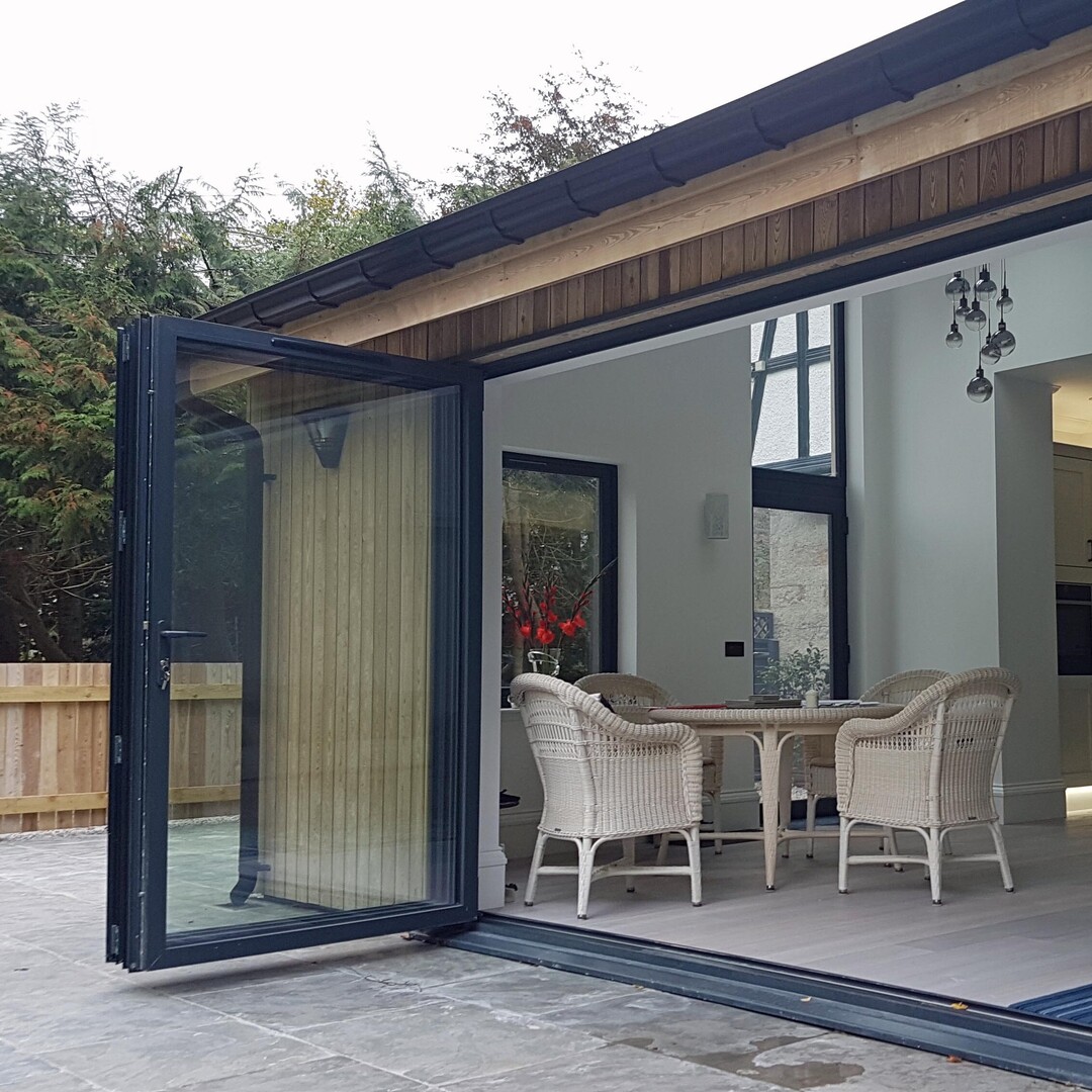 A photo of a wide opening accessible door from a family room onto a patio in Aberdeenshire